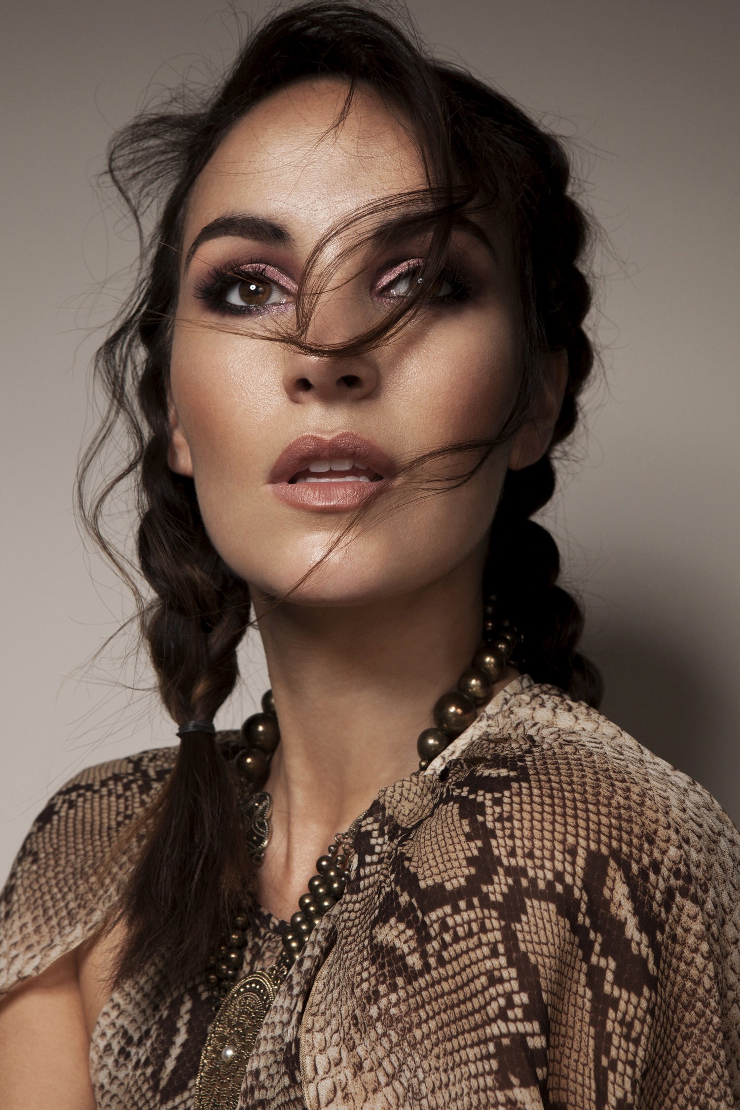 Model with braided hair and soft, sun-kissed skin for a natural beauty campaign, by organic and vegan makeup artist Em-J