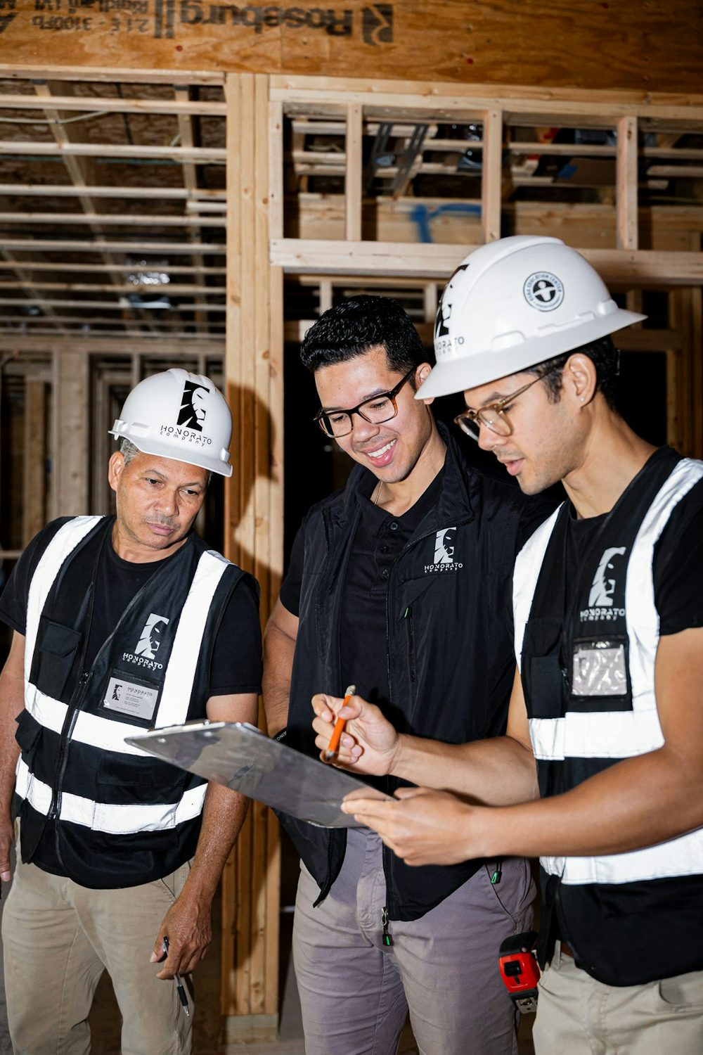 Honorato Company crew reviewing plans on an active job site