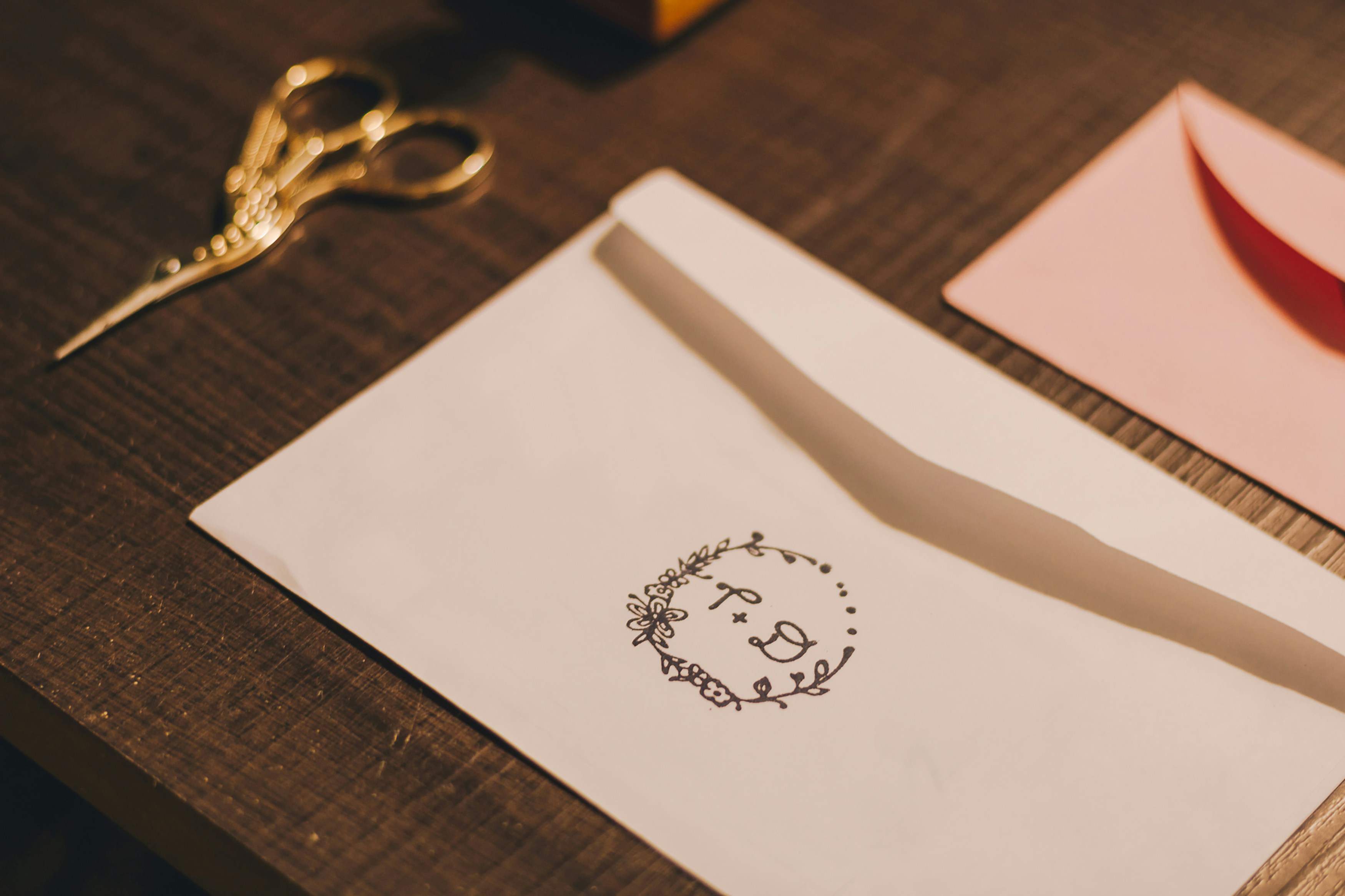 a brown envelope sitting on top of a plate next to yellow flowers