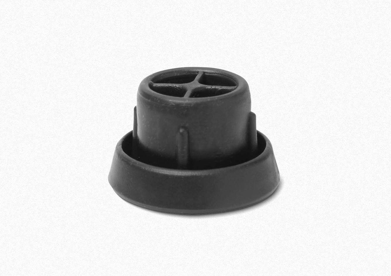 A black, circular rubber or plastic component, possibly a cap or base, viewed from above against a white background. Sapata Fixa 7/8 MR PLAST
