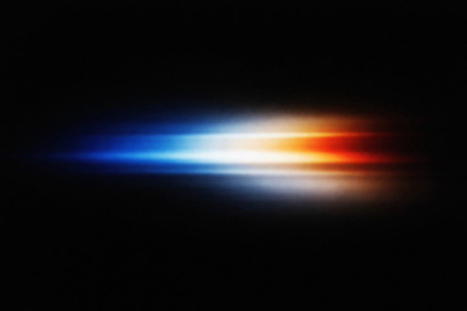 Hand holding a sleek black smartphone or mobile device against a light background