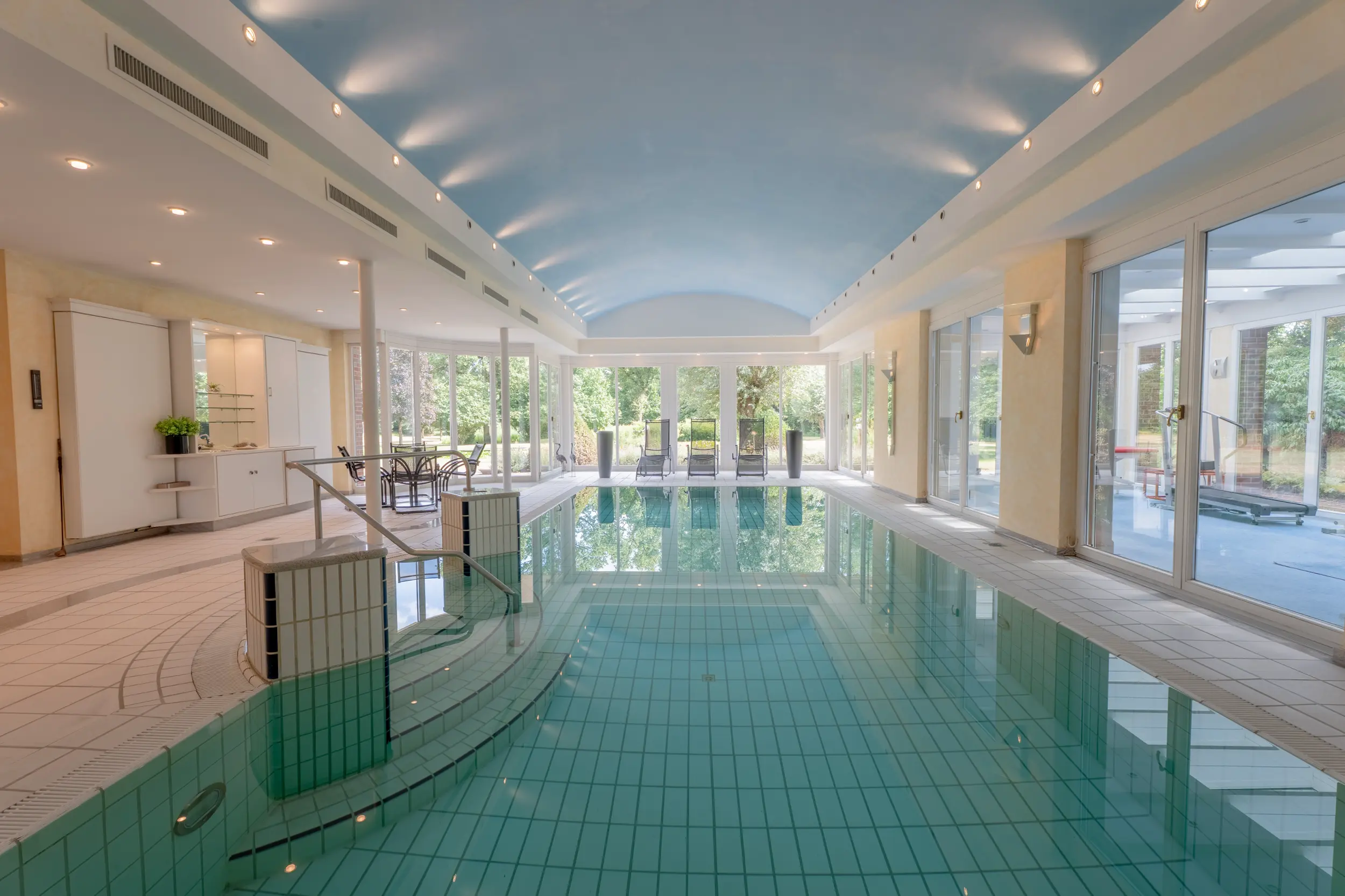 Wellness-Bereich der Villa Gronau: Großzügiger Indoor-Pool mit Sauna, Panoramafenstern und modernem Design – Westfalen Wohnen