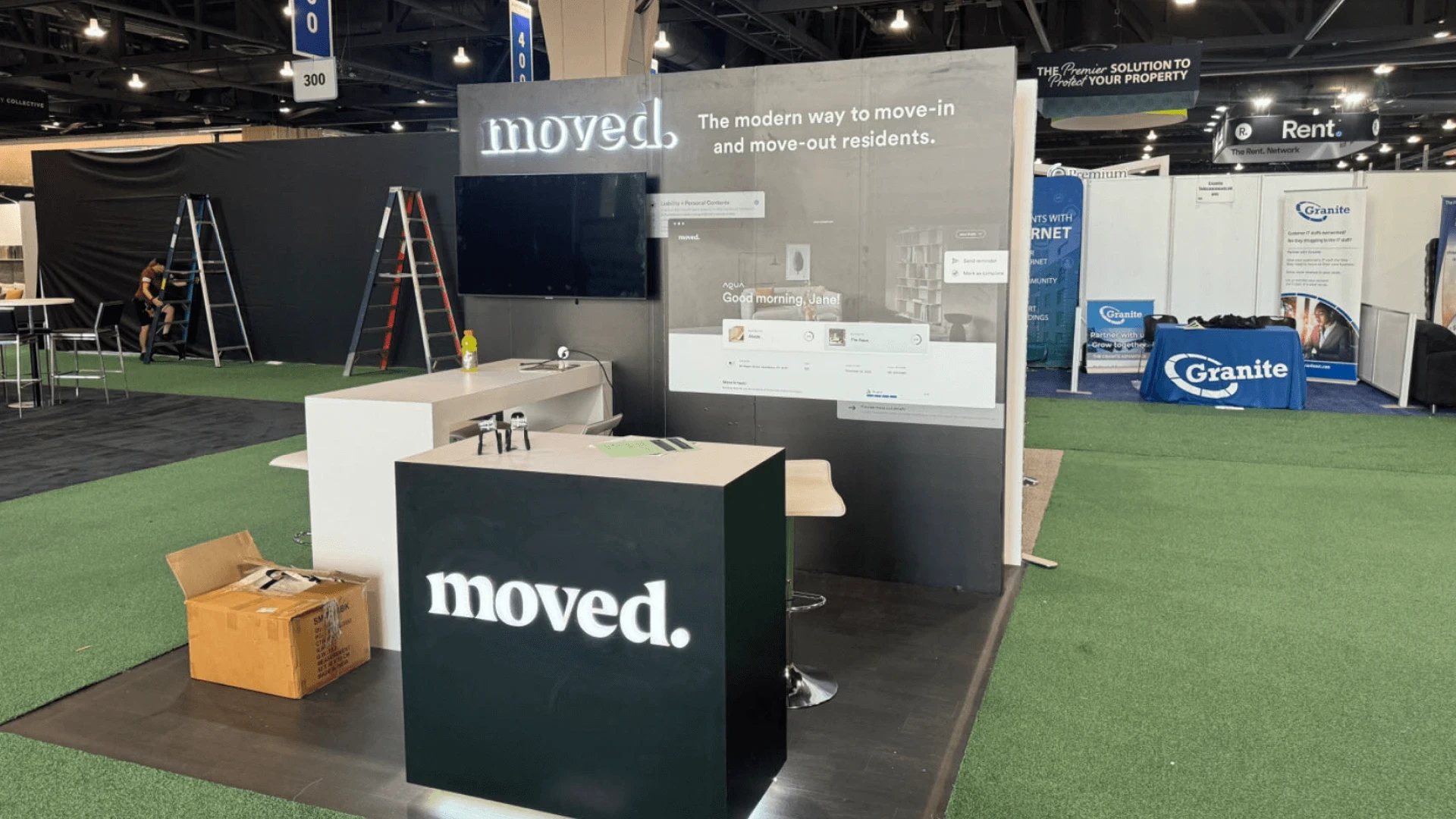 Circle Exhibit 2023 small inline booth with front reception counter, branded wall graphics, and compact visitor discussion area.