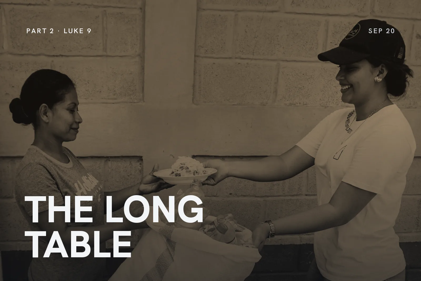 Series artwork for The Long Table: a woman handing a plate of food to a smiling volunteer