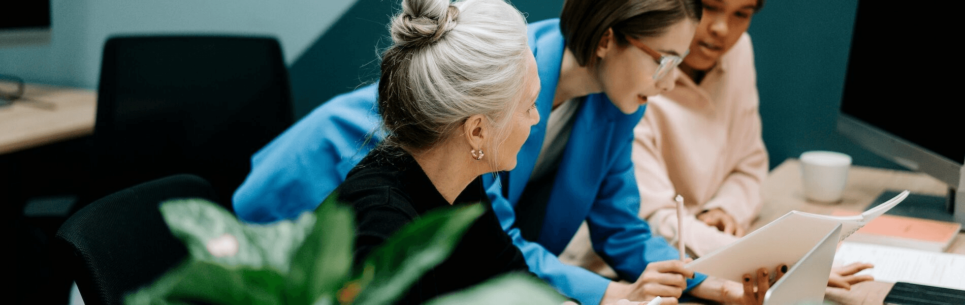 Women collaborating on documents -  Secure Enterprise Workflow