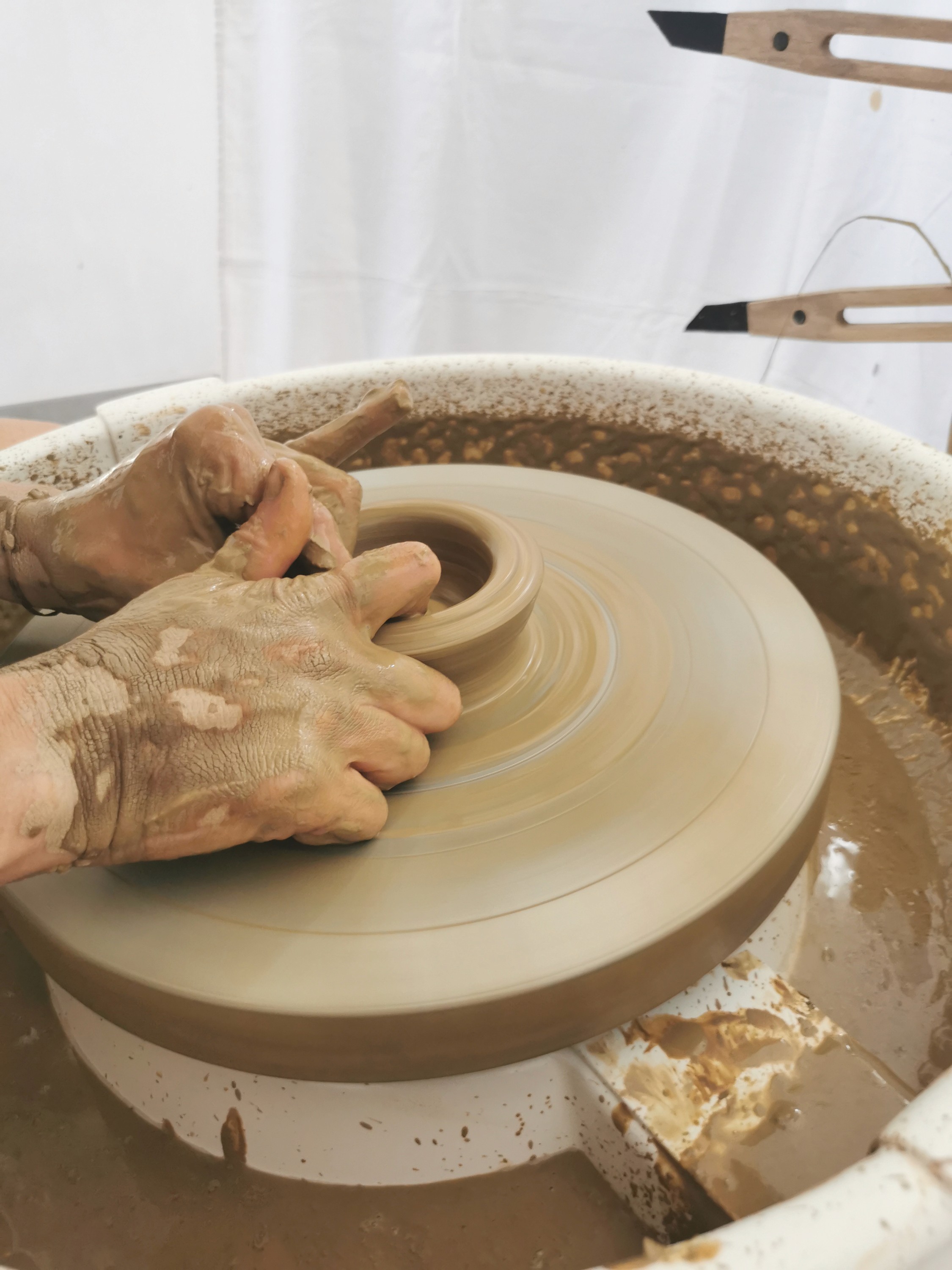 Mains de la céramiste couvertes d'argile, symbole du savoir-faire artisanal fait main – Guérande