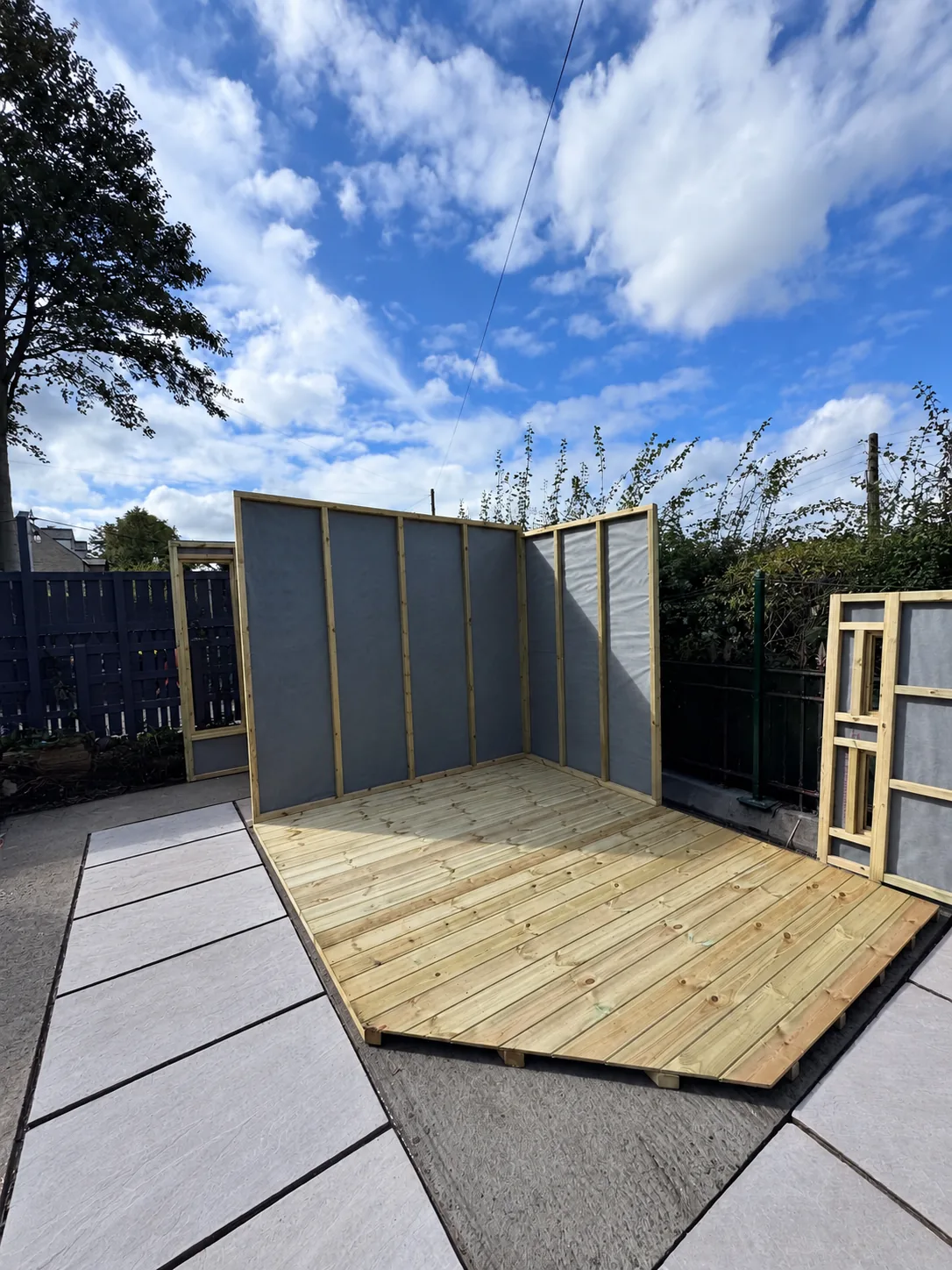Timber summer house under construction beside the new patio in Todmorden