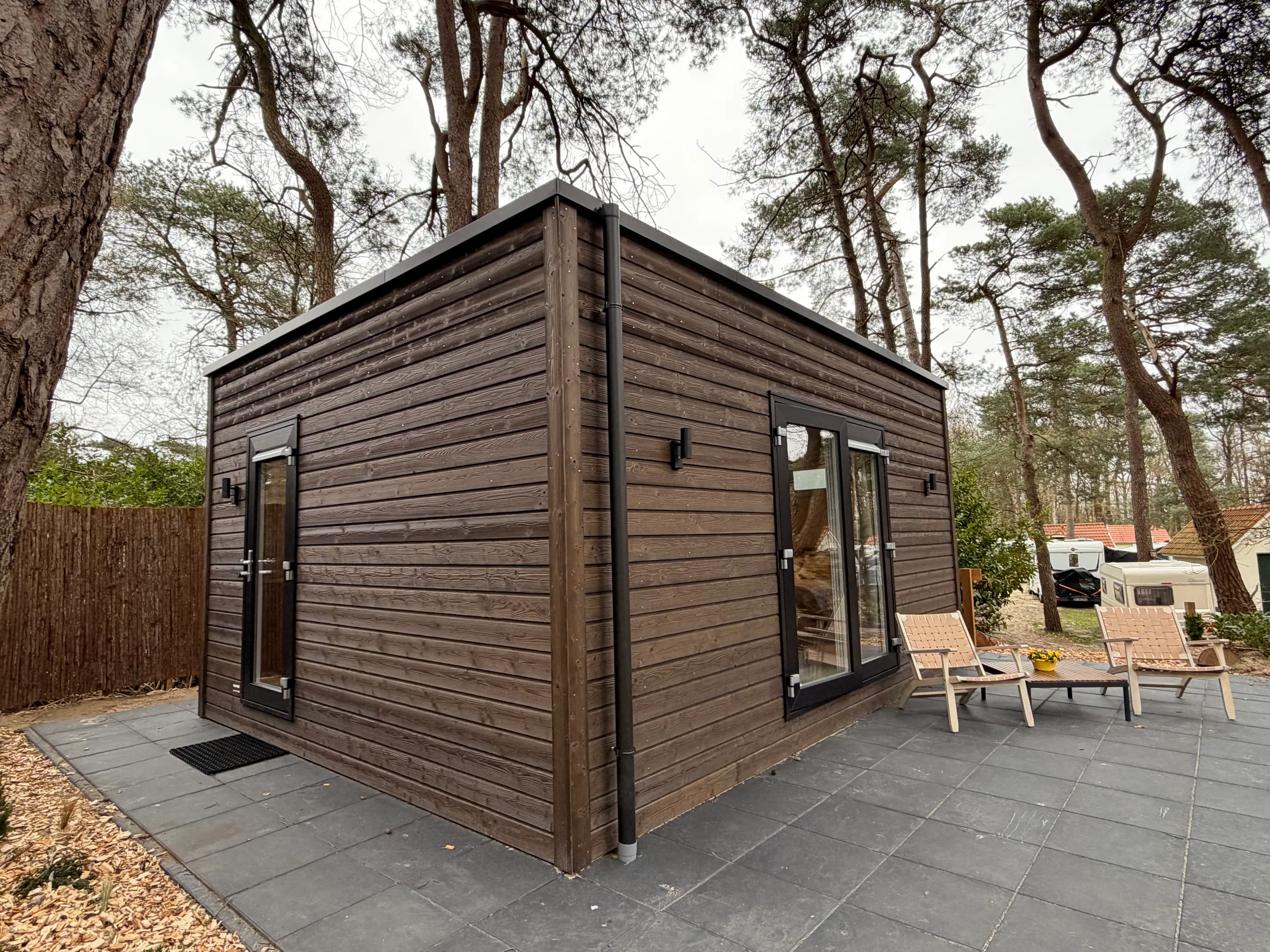 a wooden walkway between two buildings with windows