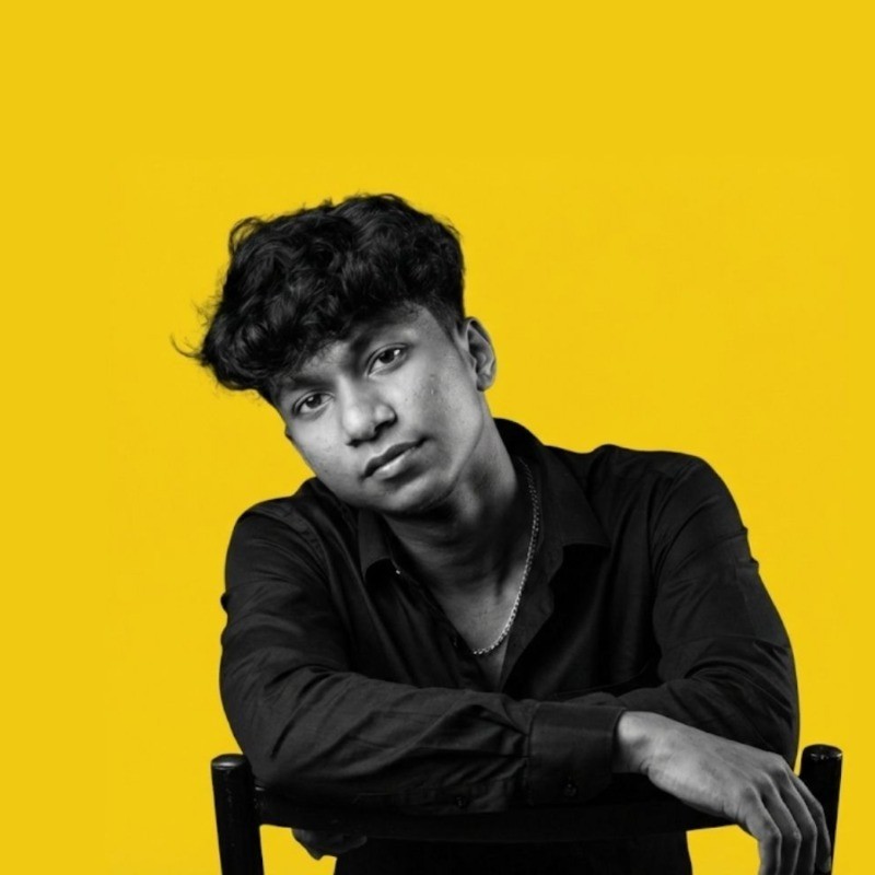 A young boy in formal attire looks forward.