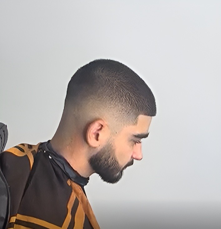Beard being trimmed with electric clippers