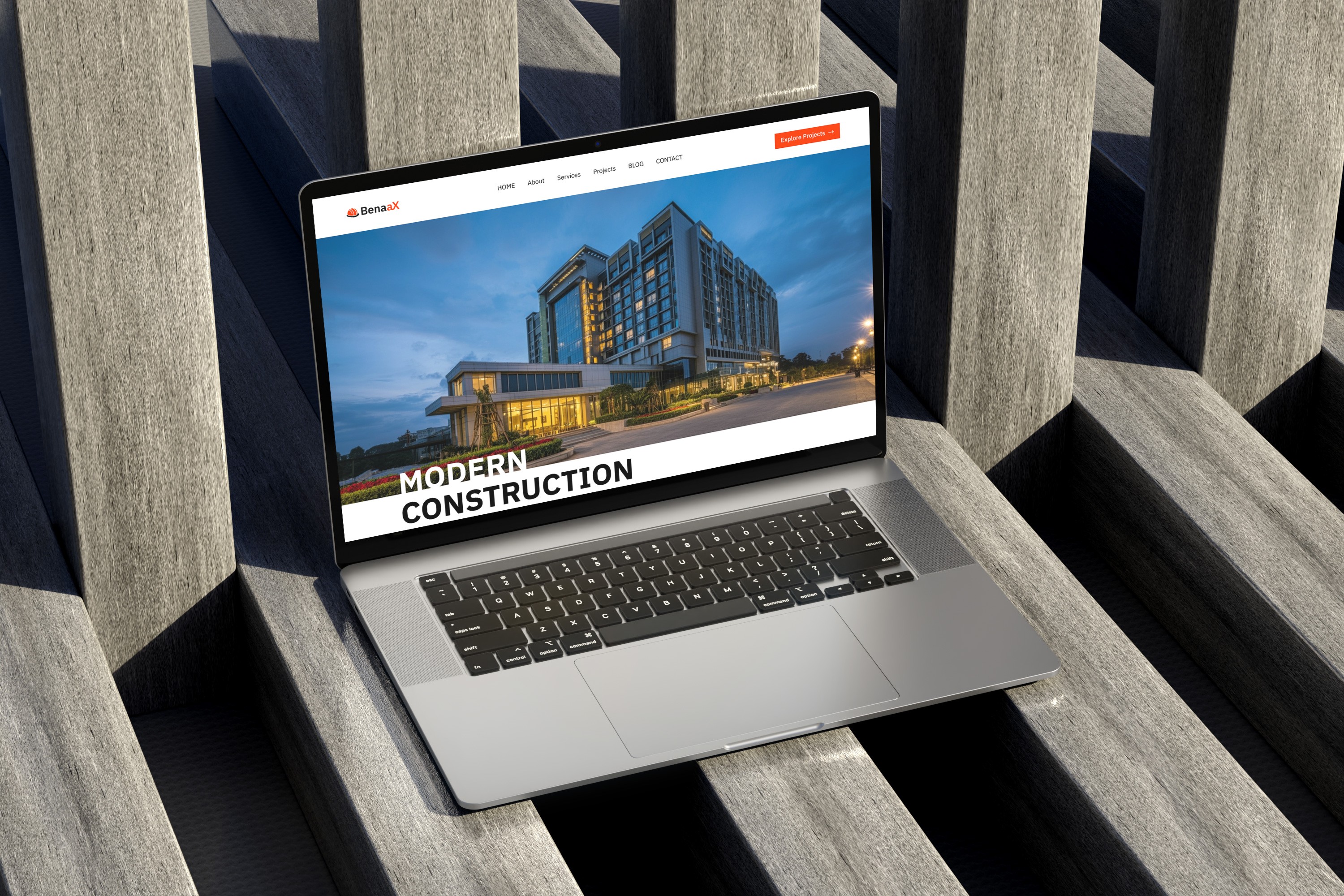 Laptop displaying website for modern construction company, showcasing a photo of a modern building.