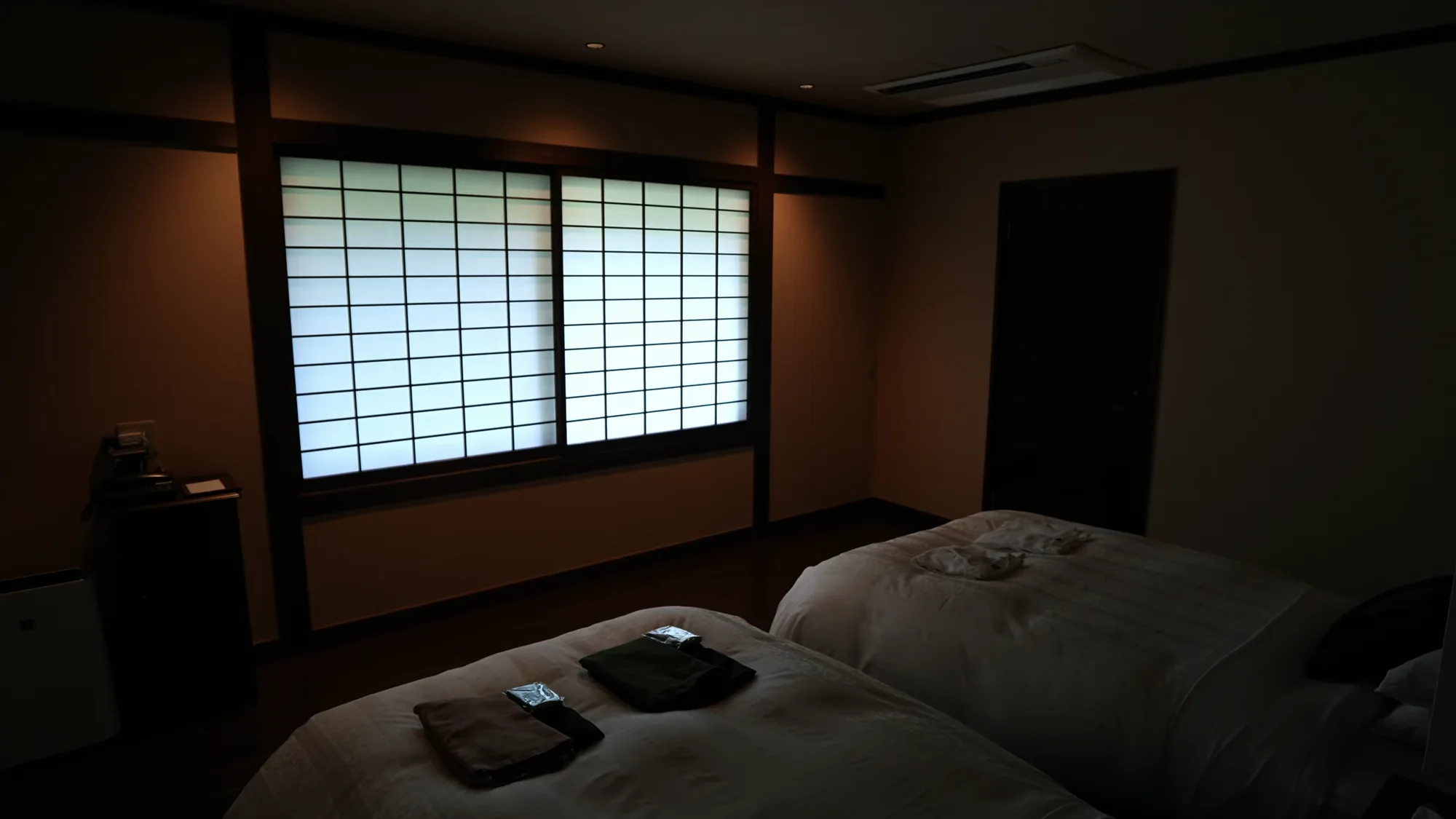 Futons laid out on tatami in a Kurokawa guest room