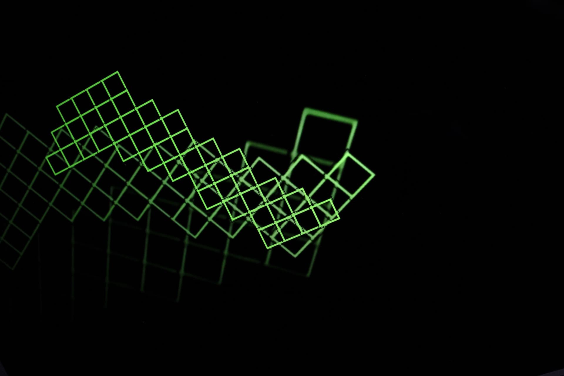 Sparse green autofocus grid pattern floating against black void, disconnected detection zones showing camera searching state without finding focus target