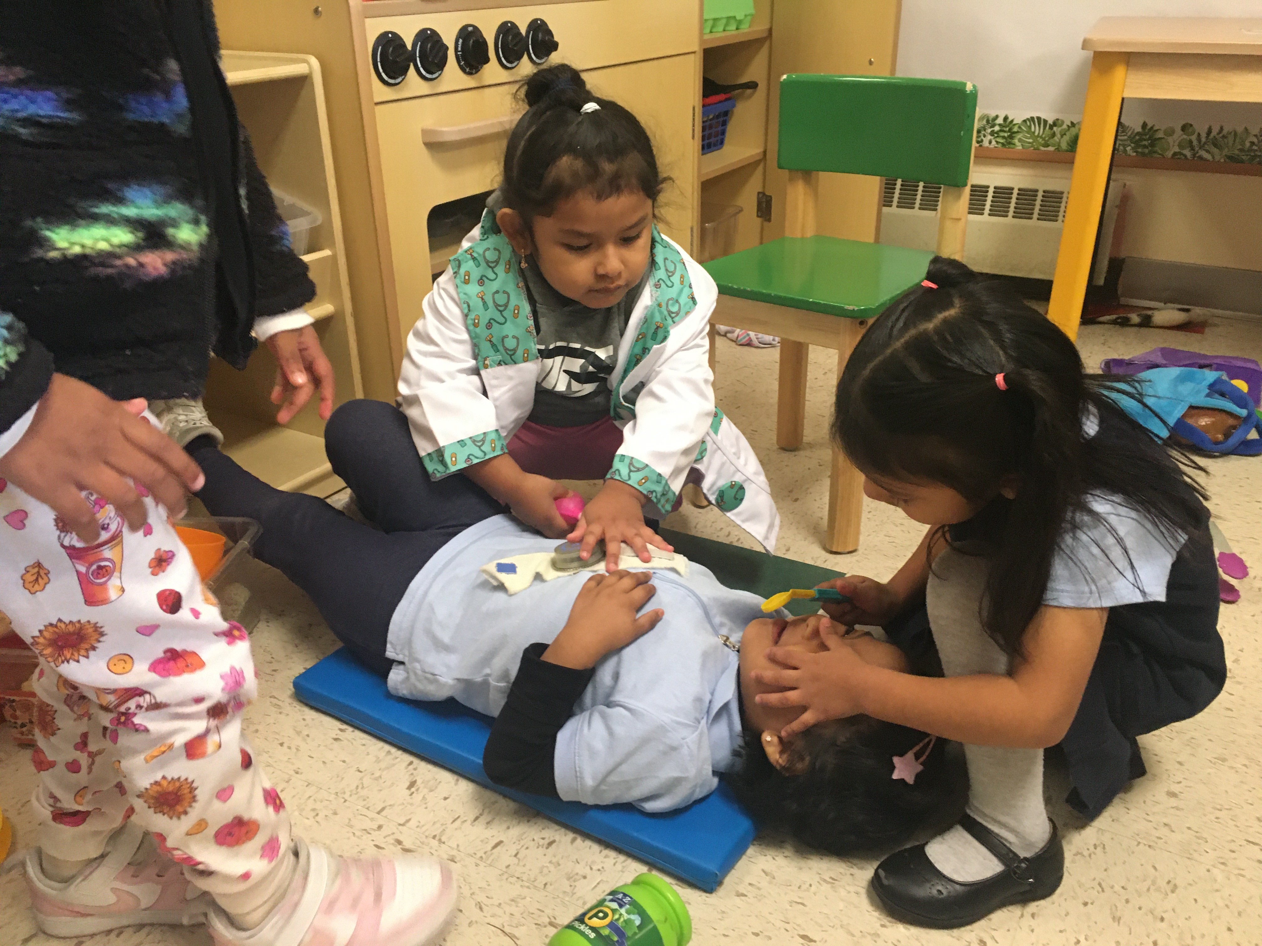 Preschoolers play act a medical test. 