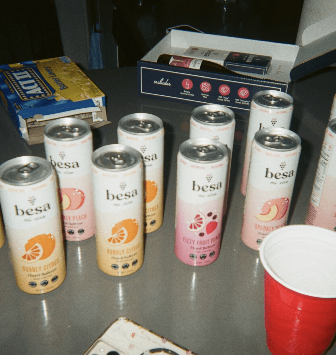 cans of hard seltzer and a red solo cup