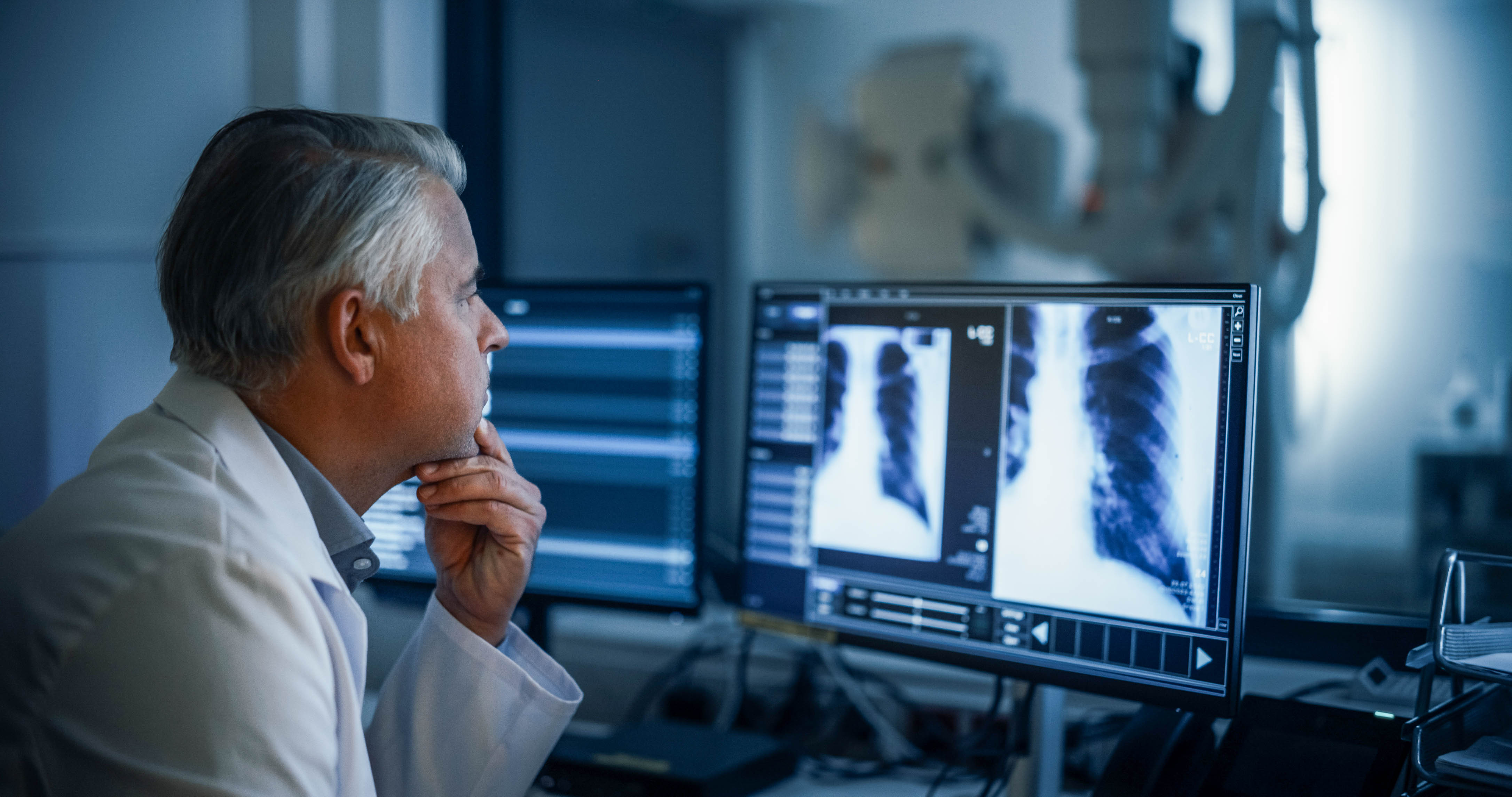 Male radiologist looking at scans