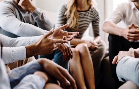 three women sitting on a chair posing for a picture