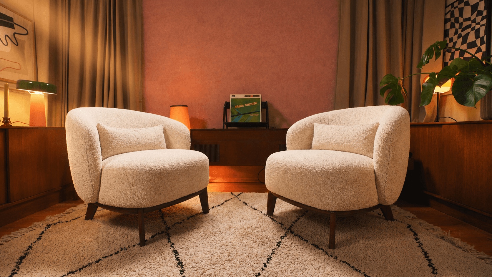 Minimalist entryway with curved walls, pampas grass, and a neutral bench under soft natural light.