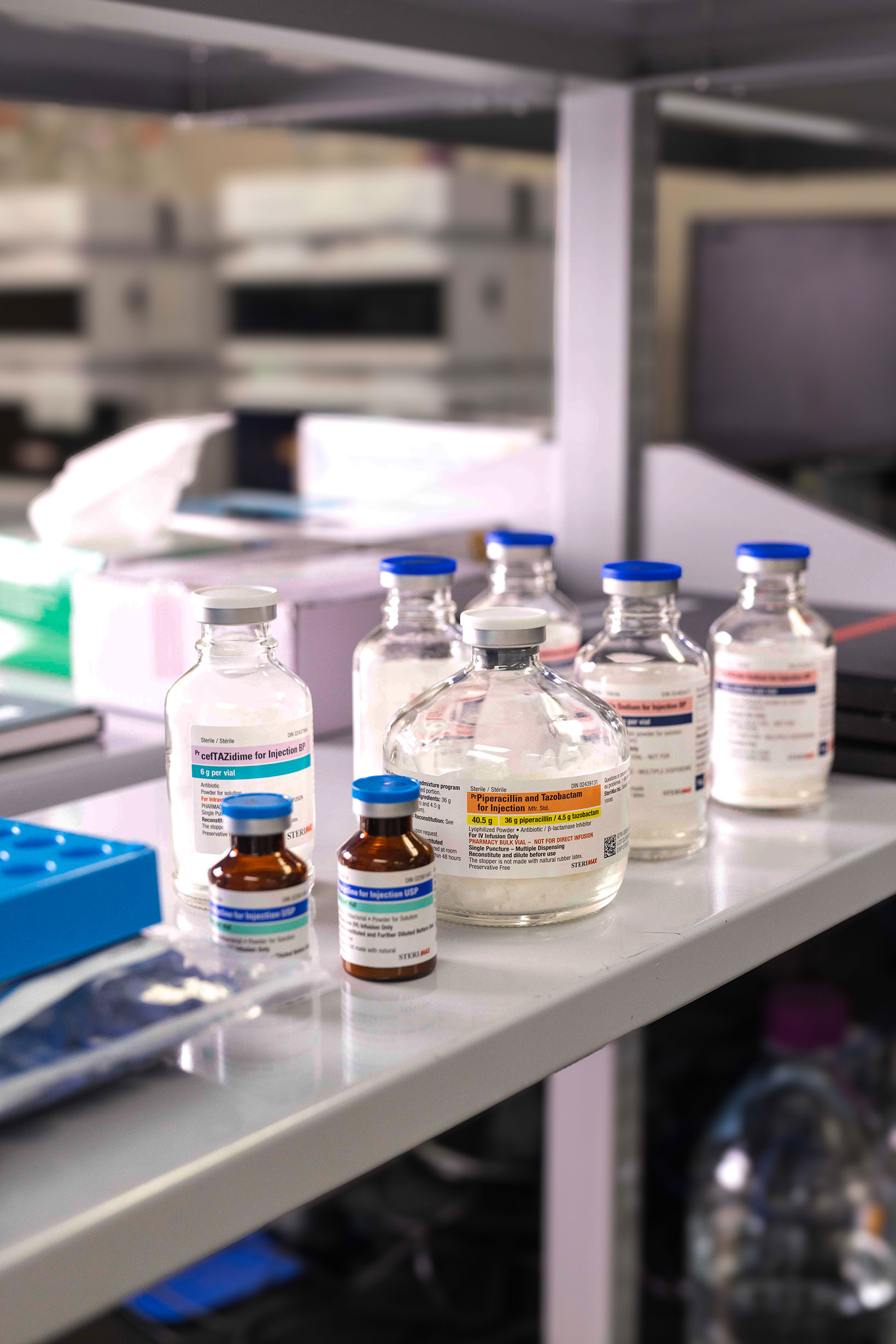 Close-up of a scientist wearing gloves carefully handling a labeled flask in a laboratory.