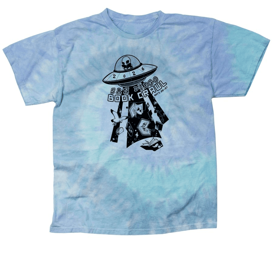 This image features a blue and purple tie-dye t-shirt with a graphic of a flying saucer labeled "2026 San Diego Book Crawl," surrounded by books, peace signs, and stars.
