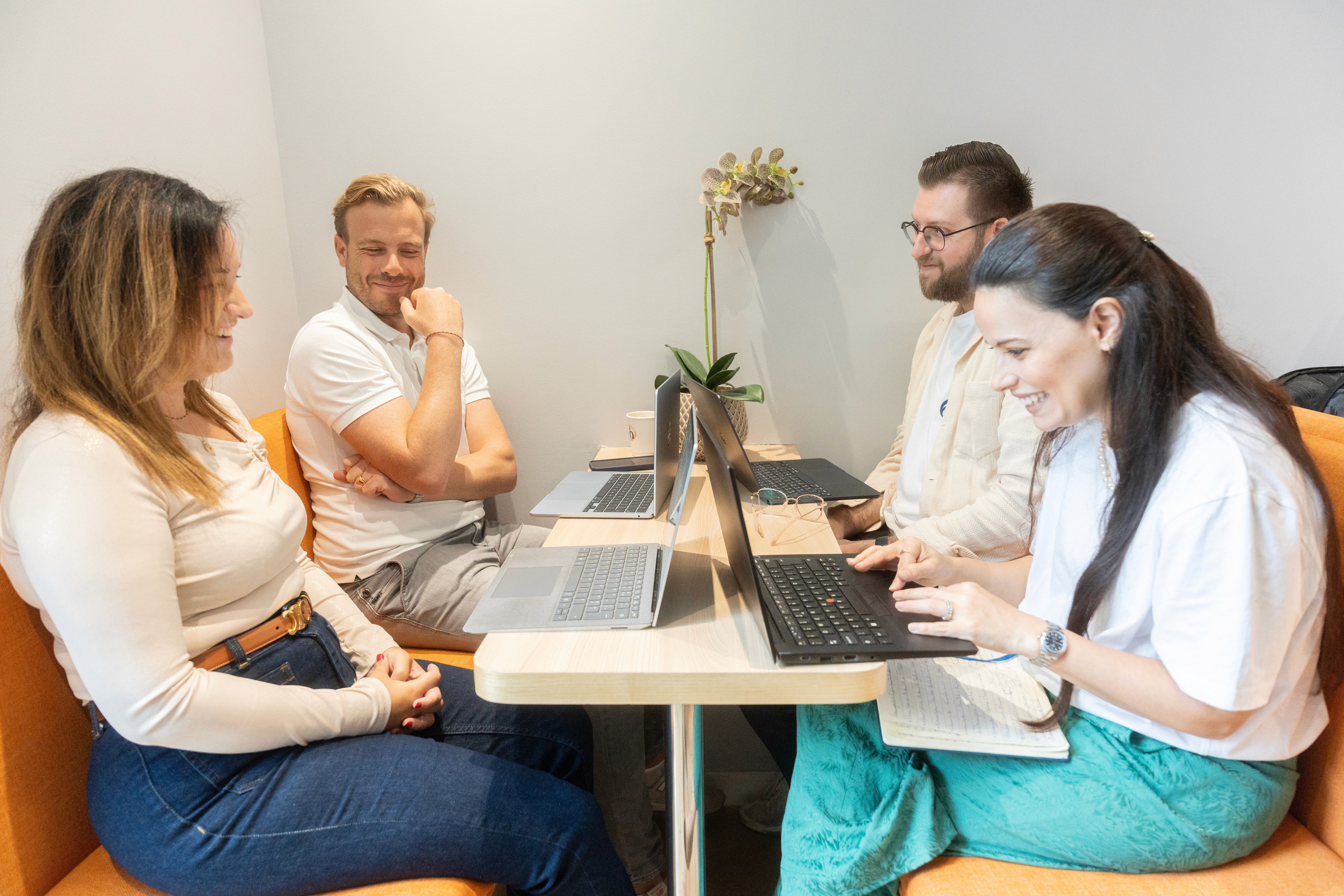 Group of professionals attending a presentation or networking event in a modern office space
