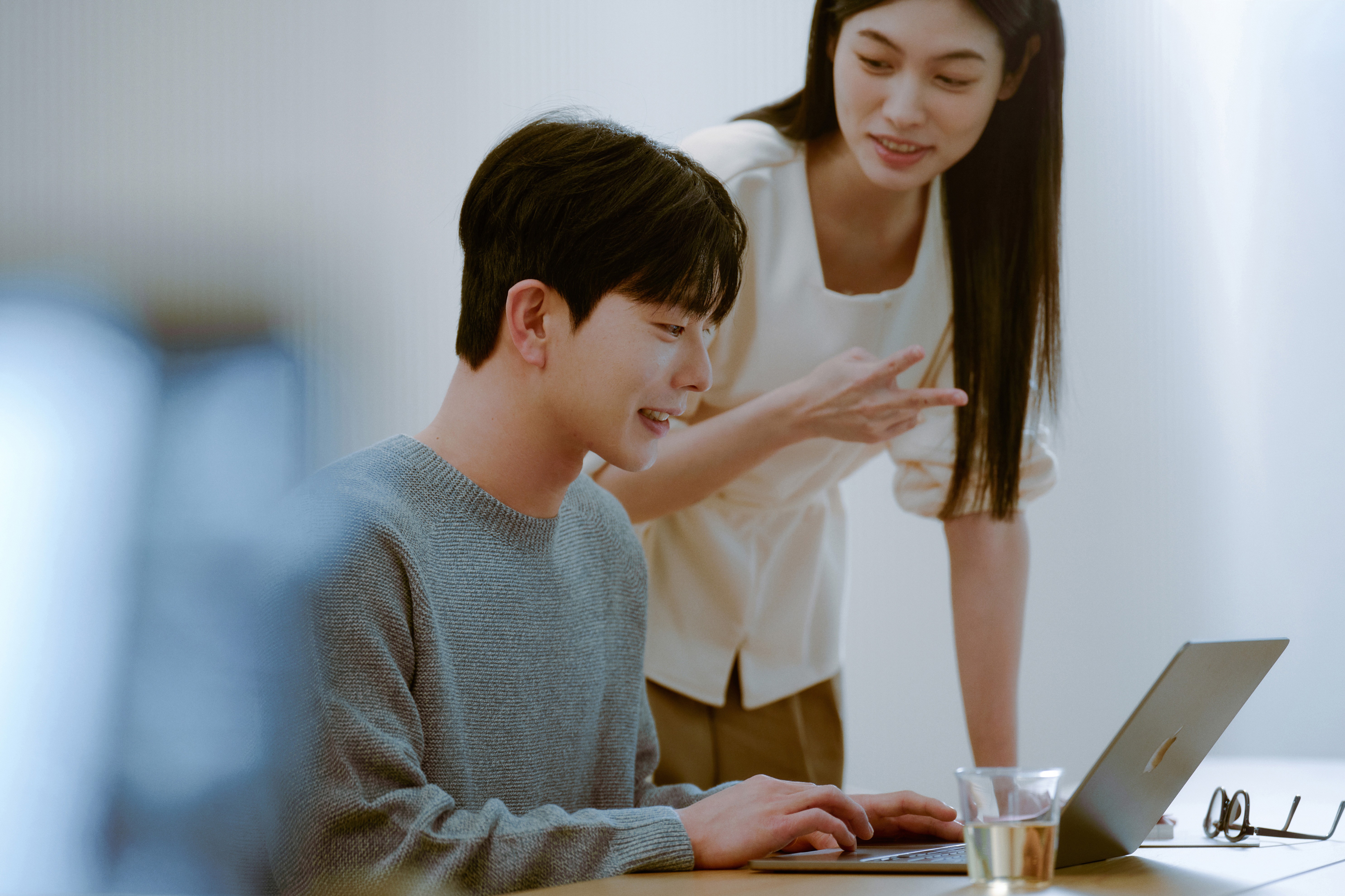 Two students smiling during a language learning session at 612 Academy, reflecting an engaging and human-centered learning experience.