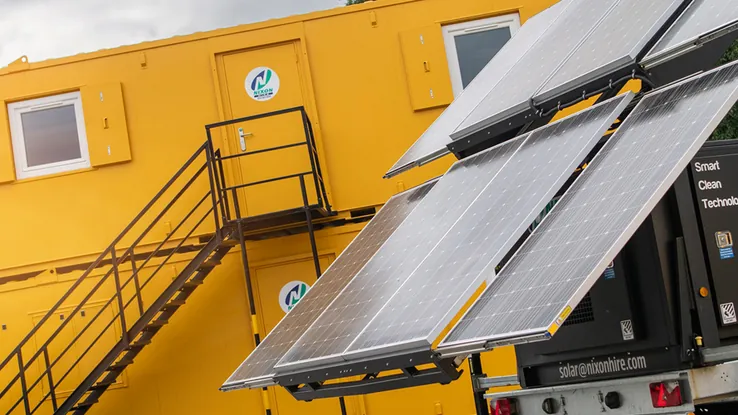 Mobile solar hybrid generator and site accommodation units at a construction compound.