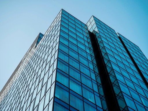 blue and yellow curtain wall building during daytime