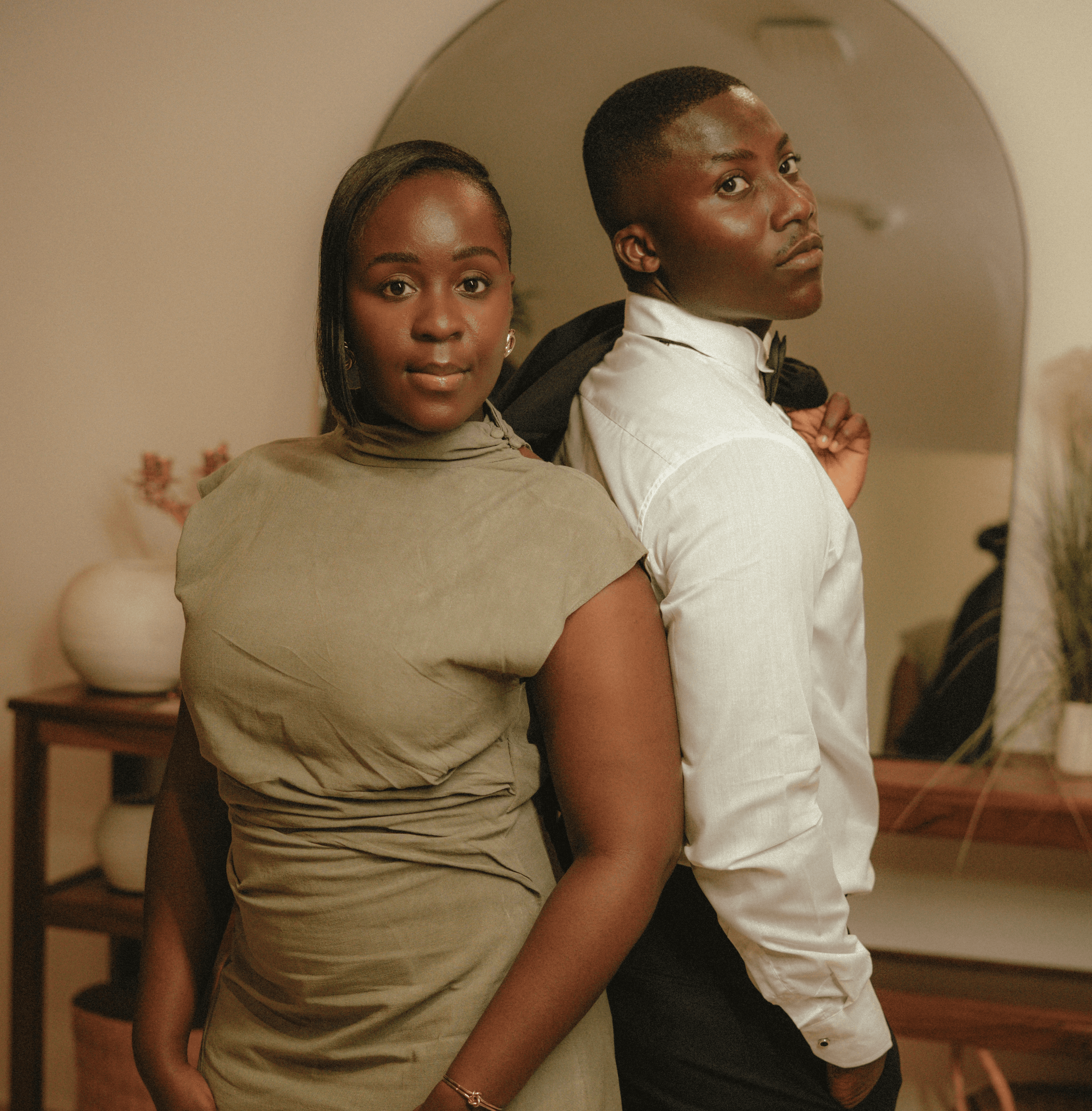 a couple holding hands while standing next to each other