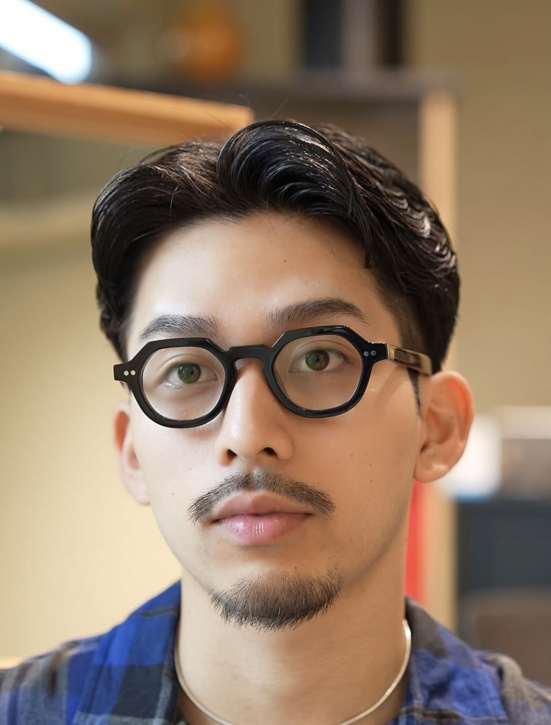 Profile portrait of a man in a grey shirt