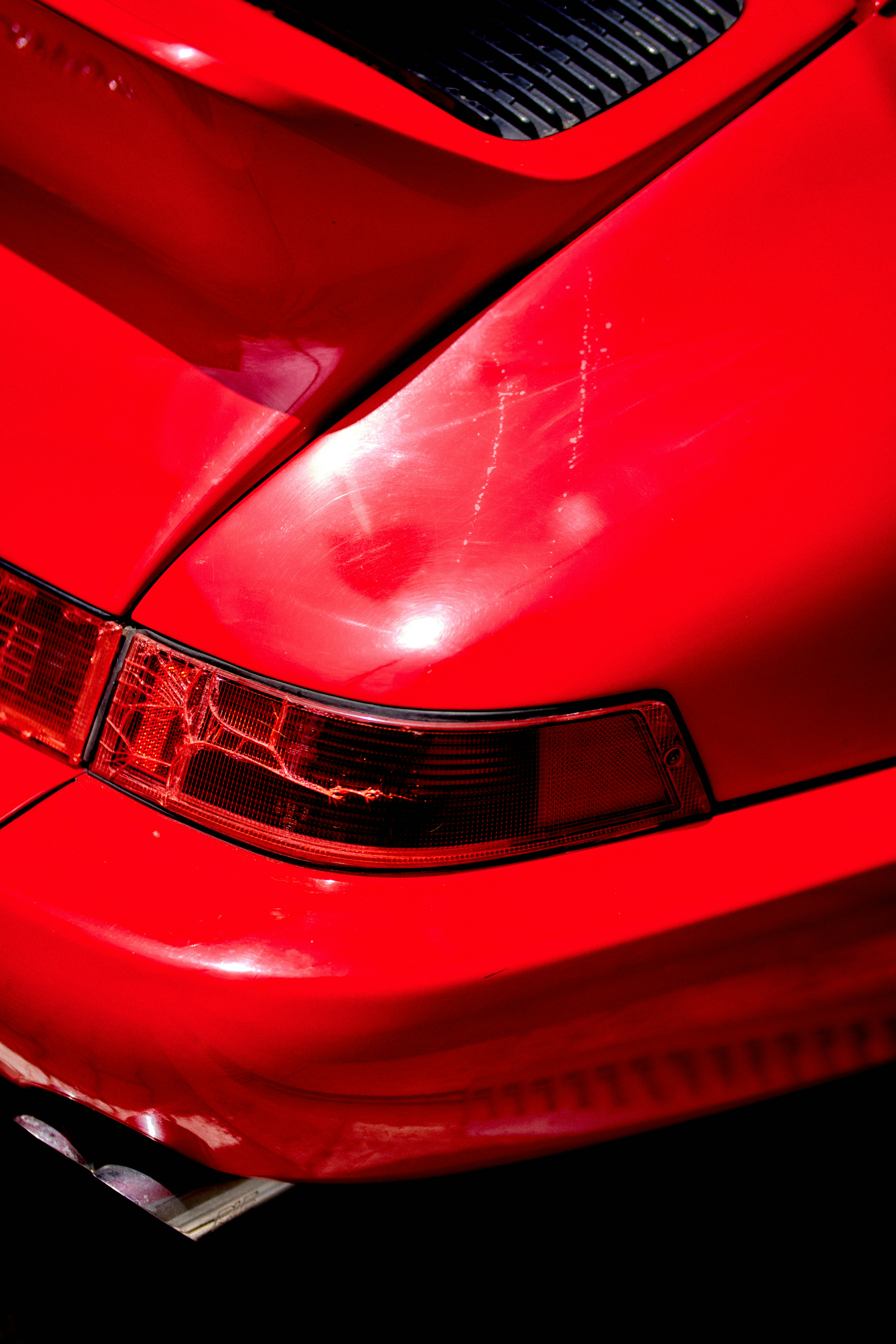 Bright red car's rear end, close-up.