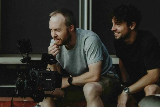 Reilin sitting next to a camera man