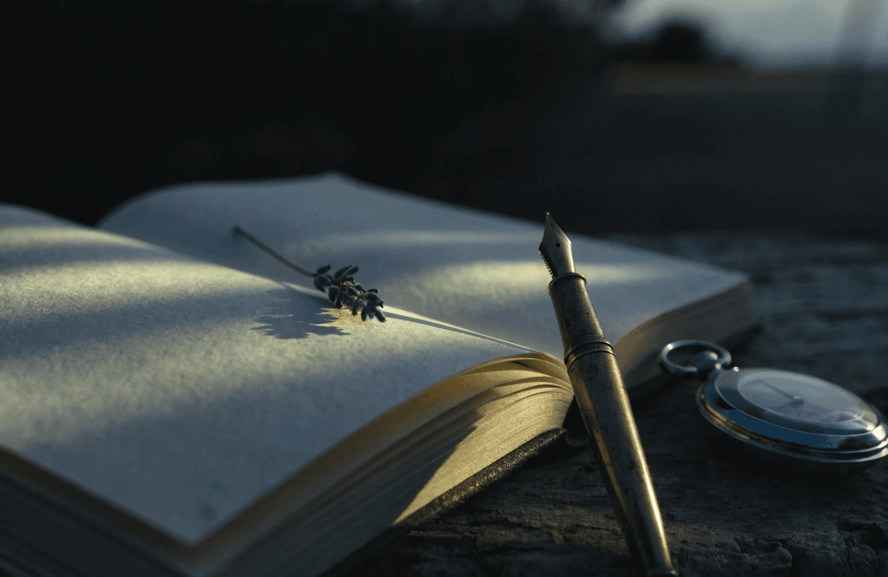A realistic macro photograph of an open linen journal resting on a dark rustic table during a warm, soft sunset. Next to the journal sits an antique #8C7D64 Aged Bronze fountain pen and a single, polished #A3AEC4 Sacred Silver pocket watch. Chiaroscuro lighting: Warm, golden candlelight streams across the paper, leaving the edges of the frame in deep #0F151E Celestial Shadows.
