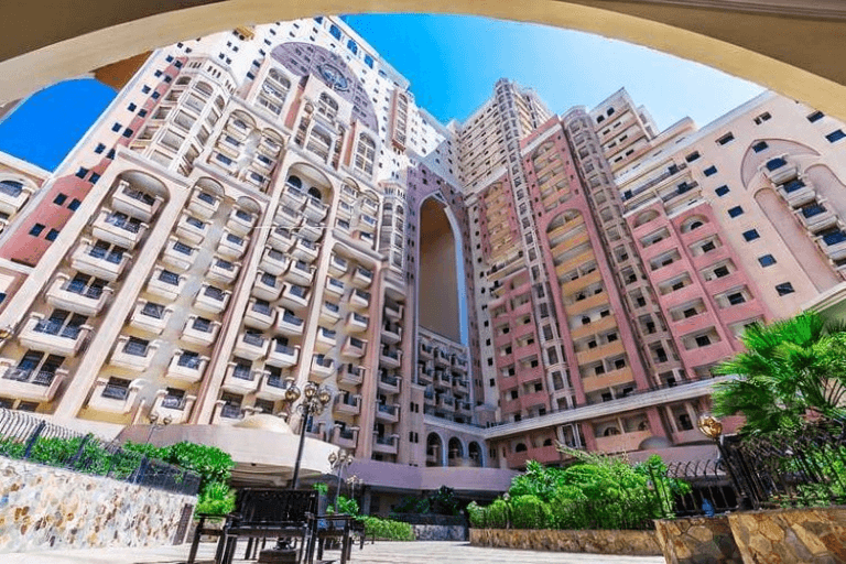 Aerial view of modern office and residential towers, highlighting premium investment properties in our portfolio.