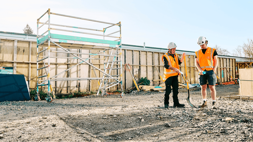 Two construction workers at a construction site