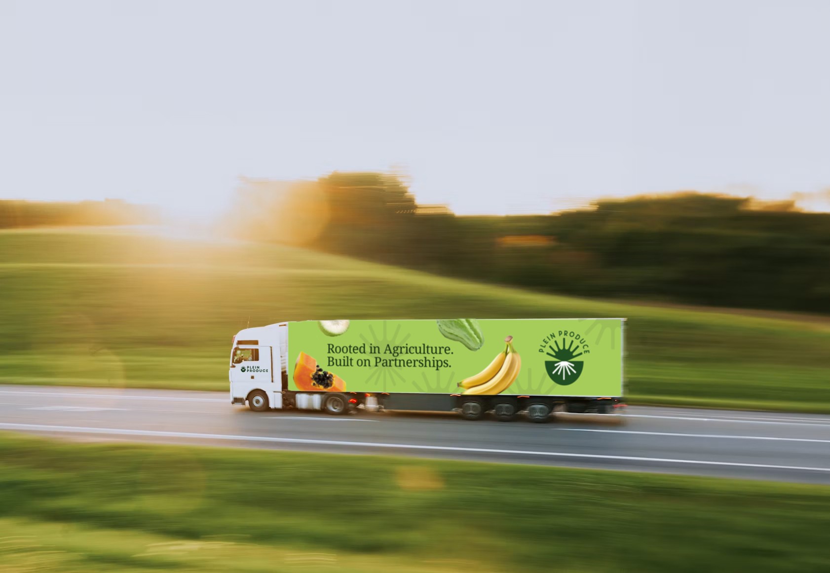 Plein Produce truck driving past green fields