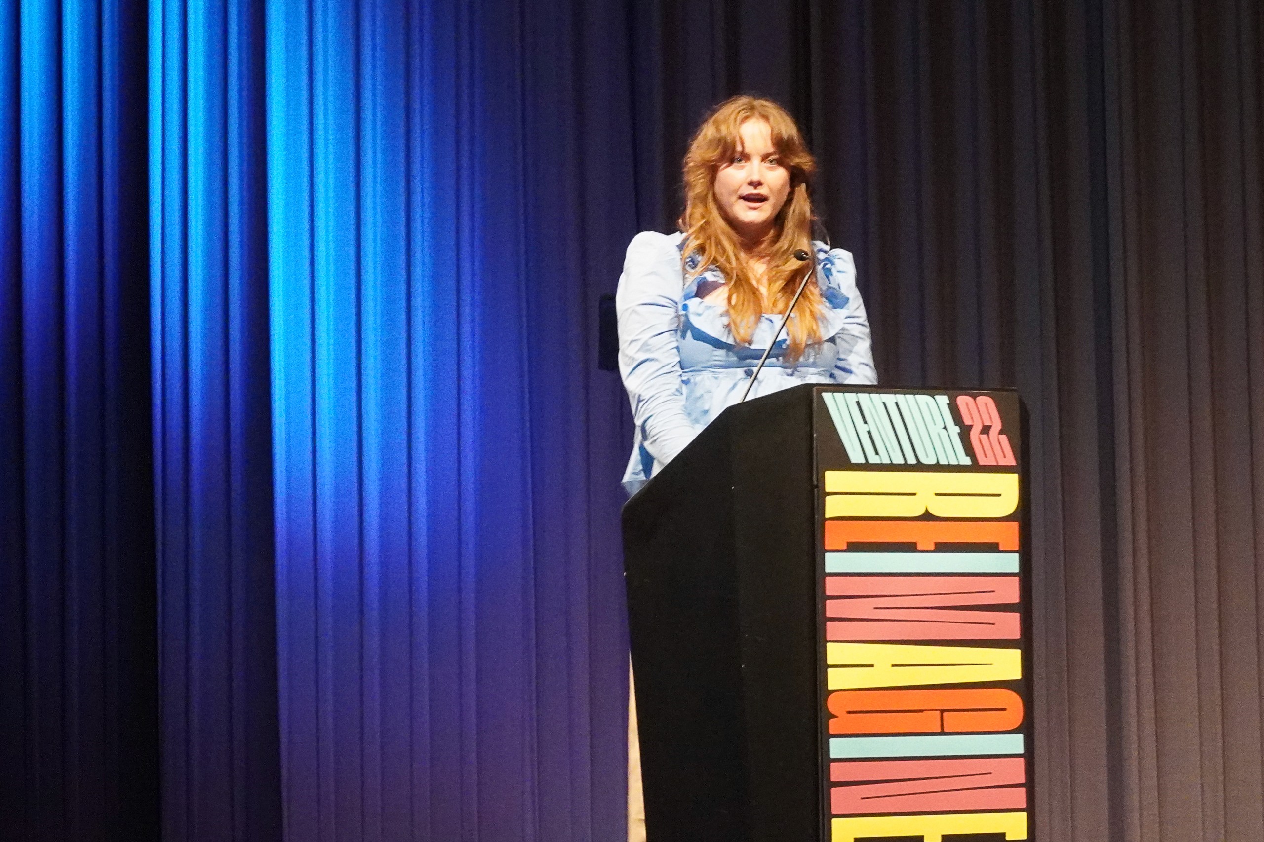 Krista speaking at podium 2
