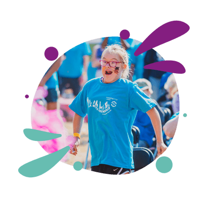 Child running with colorful splatters
