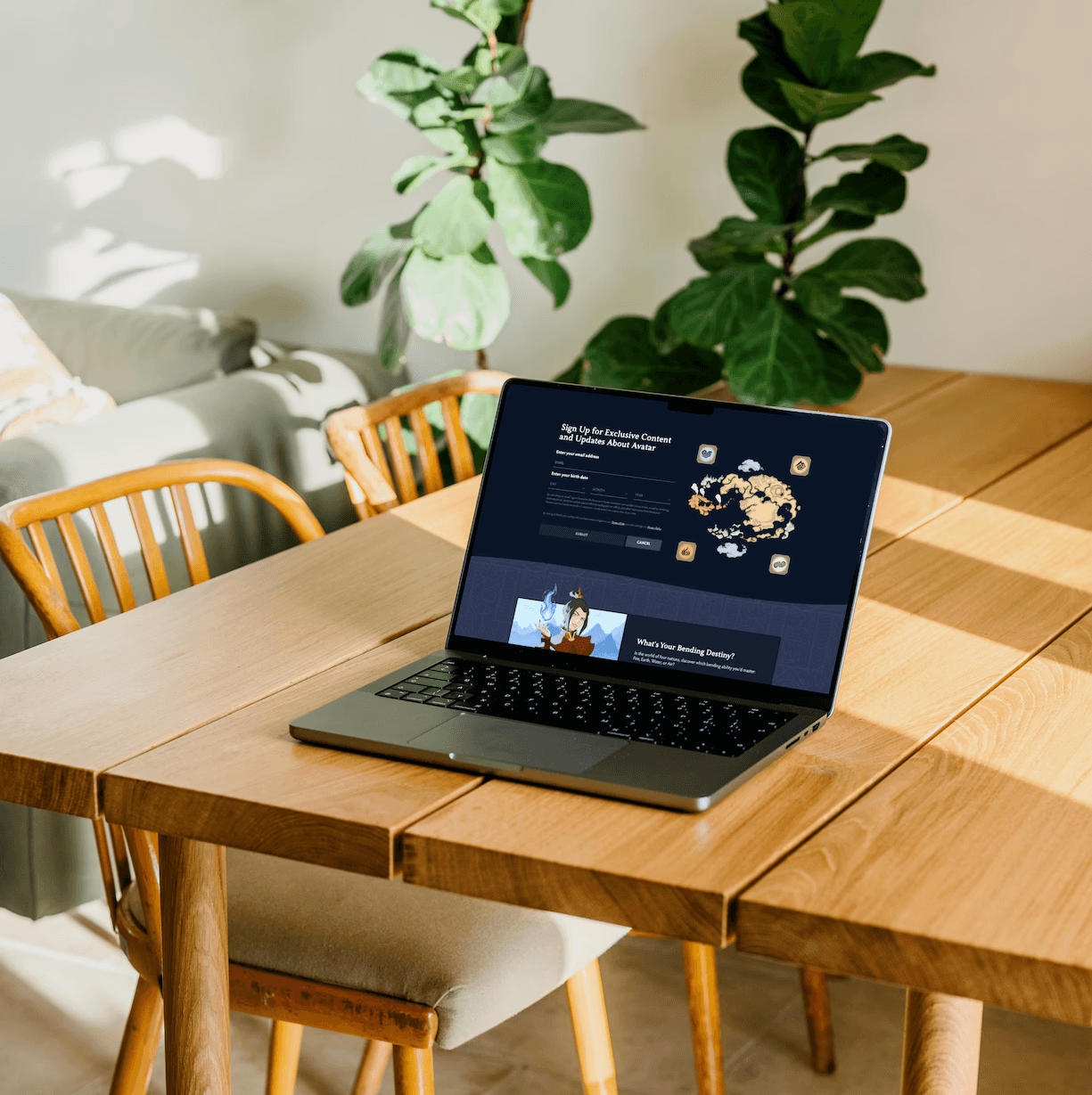 Fluid web design of a newsletter sign-up form and illustrated character card shown on a laptop in a sunlit room with wooden table and plants.