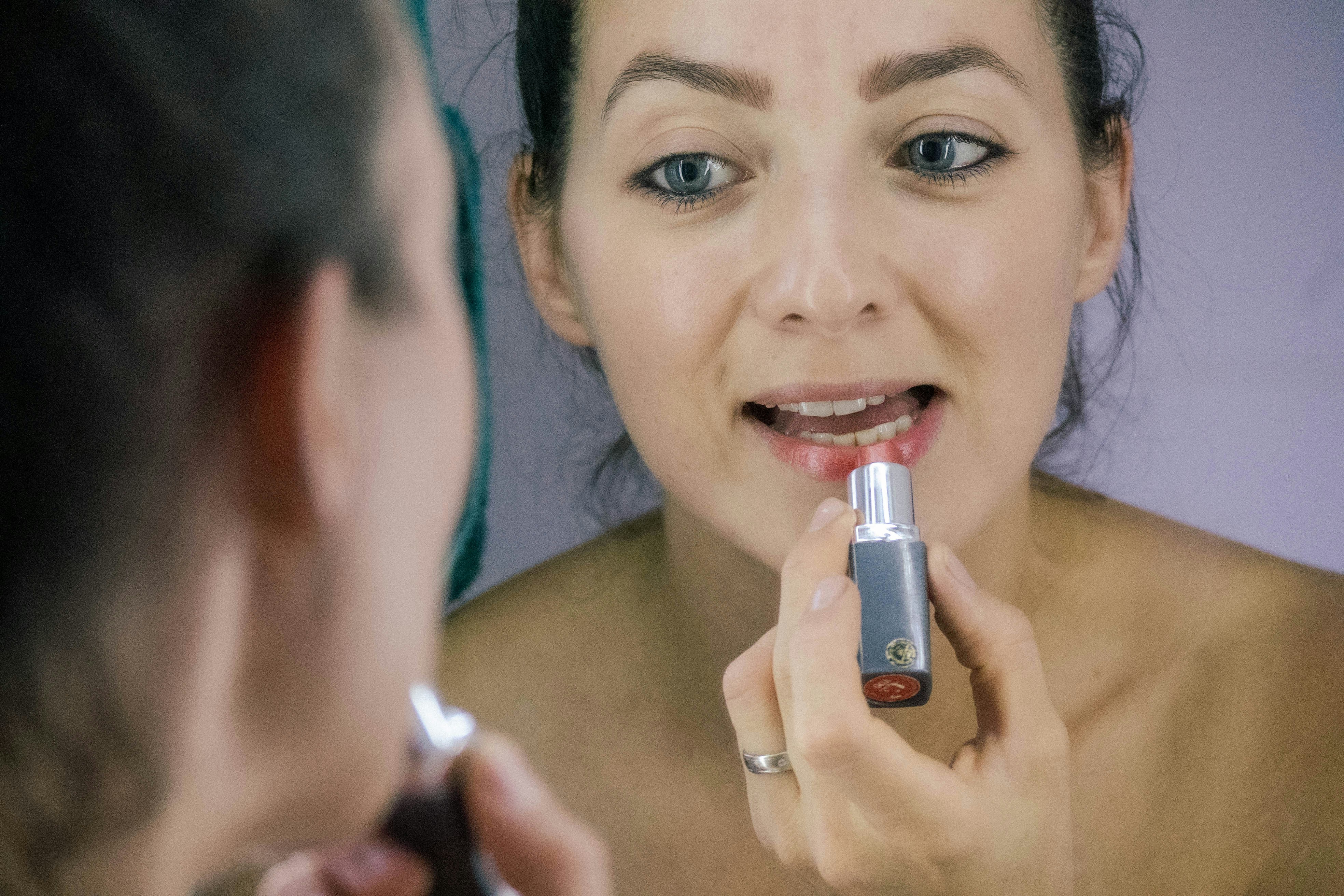 a woman brushing her teeth in front of a mirror