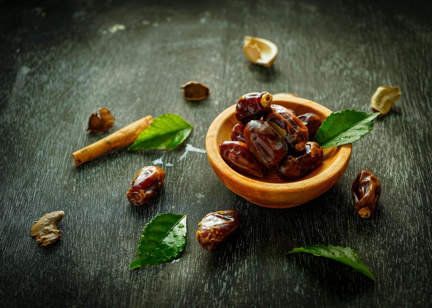 small bowl with dates and leaves around it