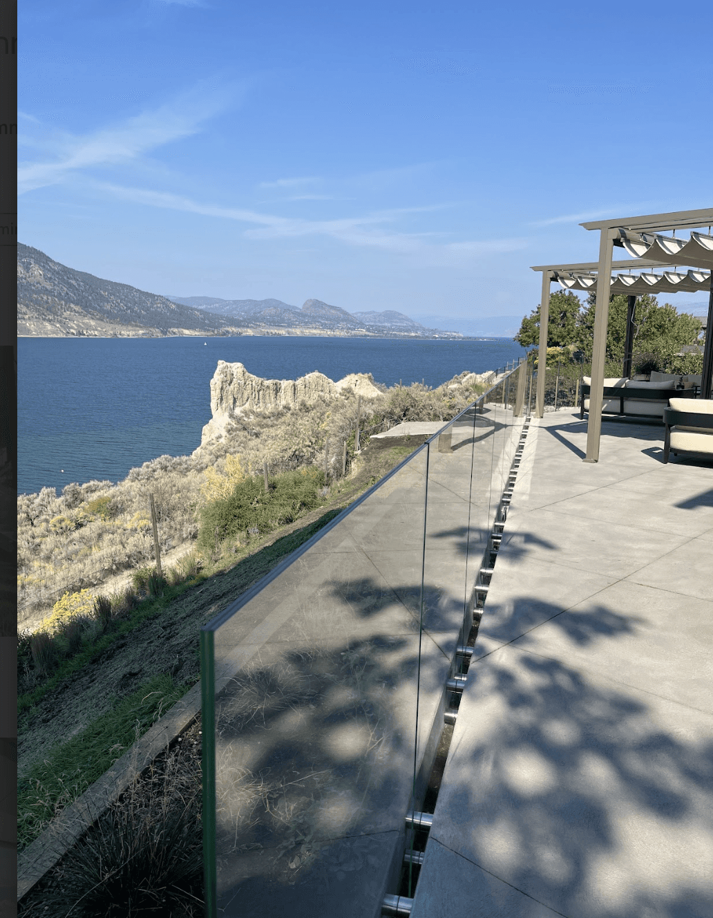 Glass railing with stainless hardware on a BC lakeside patio