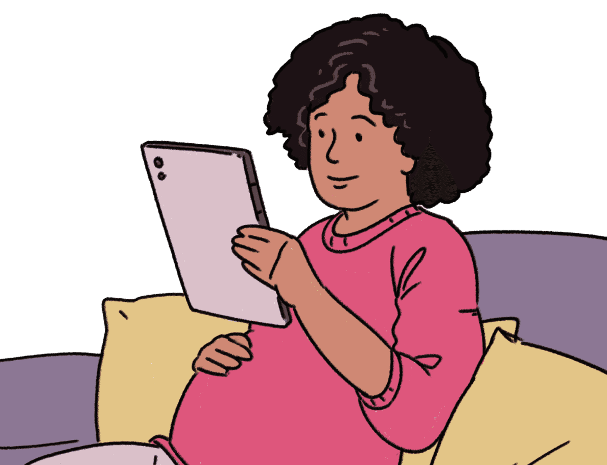 A black pregnant lady wearing a cream coloured hoodie and black trackpants with her hair tied up sits on a peach-coloured comfy bench. She is holding and reading a pamphlet. She looks relaxed and engaged in the material, she is also holding her belly.