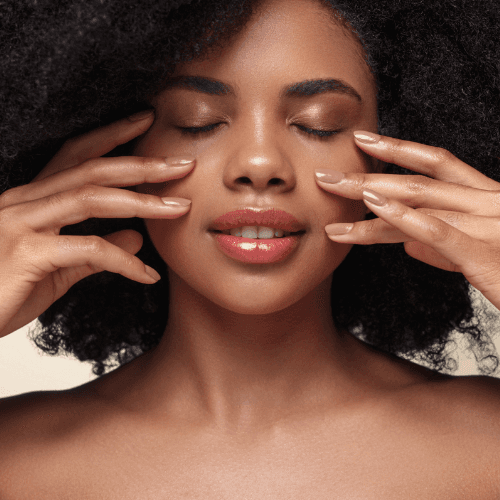 african woman touching her face with both hands