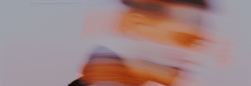 Abstract image with swirling colors, primarily warm hues, creating a dynamic and fluid effect.