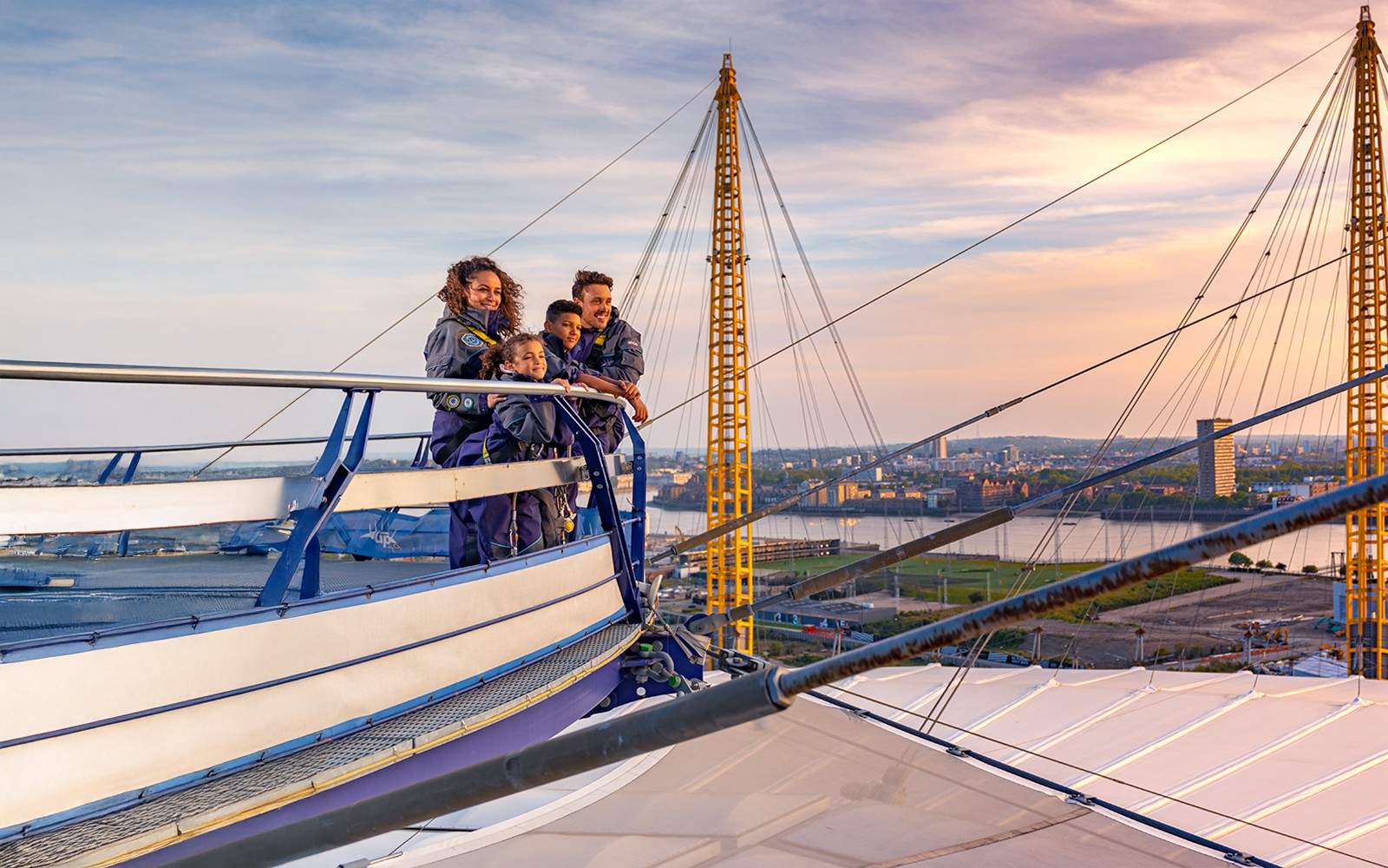 Guests enjoying a sunset view at The O2 Arena, London, with the city skyline in the background.