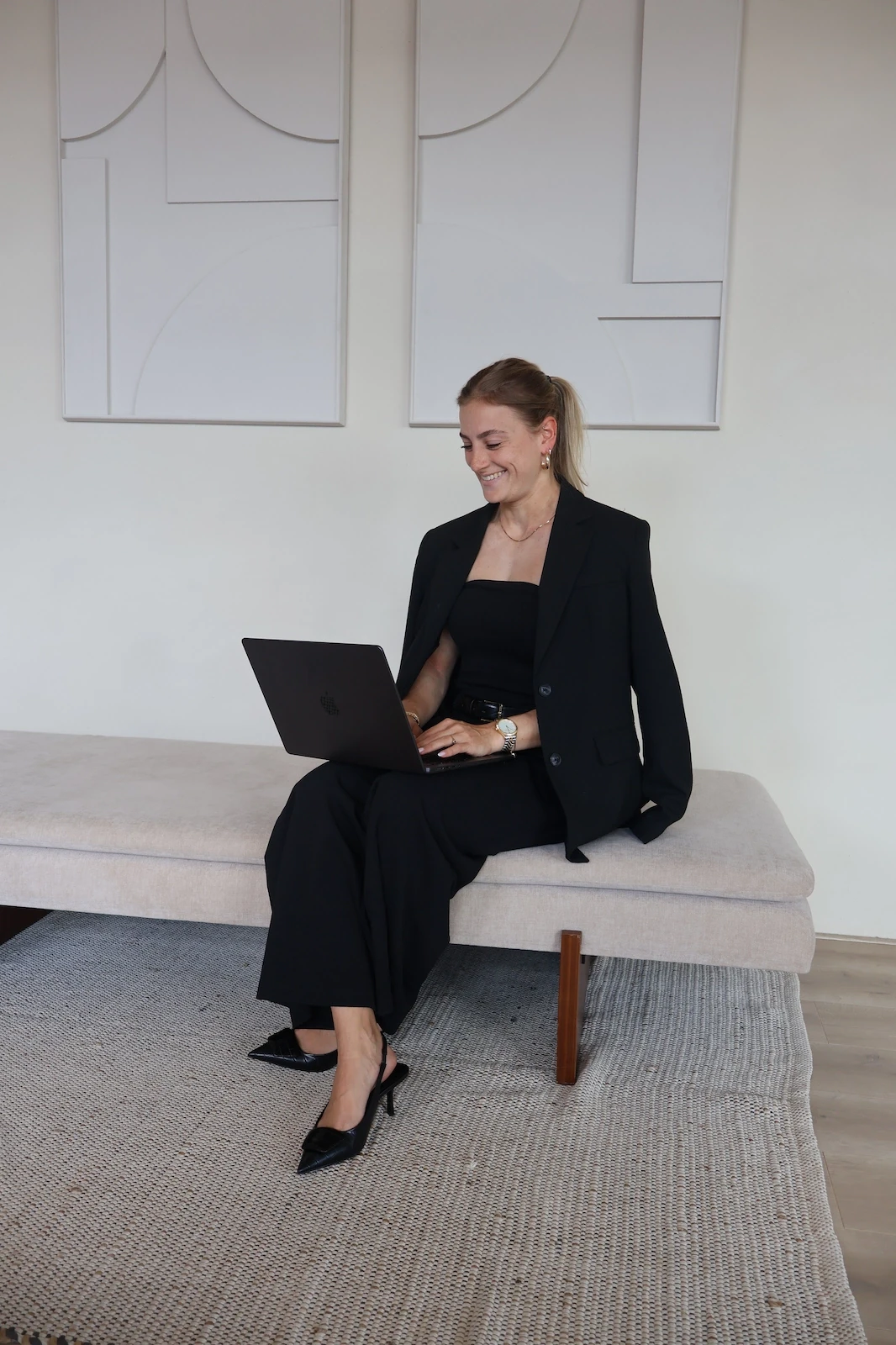 Woman in a beige turtleneck by an old computer and TV, retro 80s office portrait.