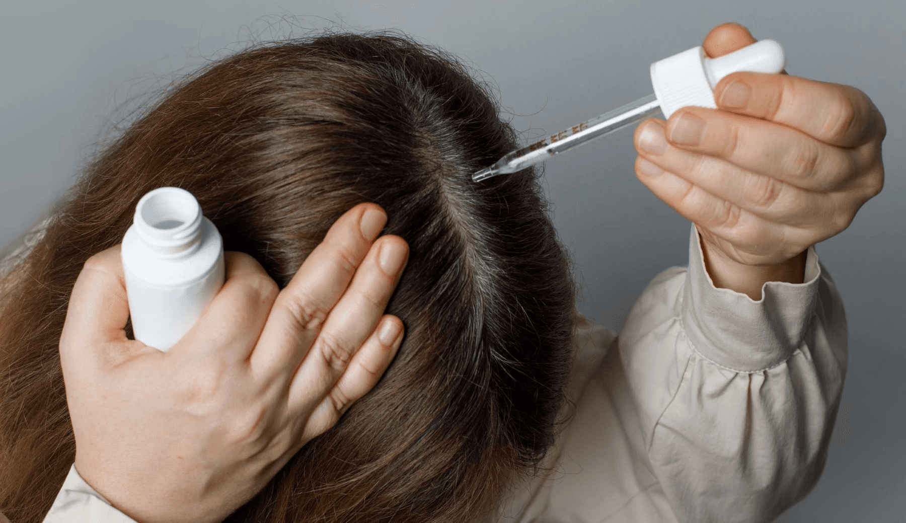 Person applying hair serum with a dropper - Does Semaglutide Cause Hair Loss