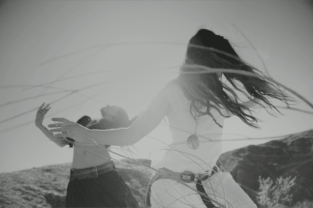 Two people stretching on yoga mats