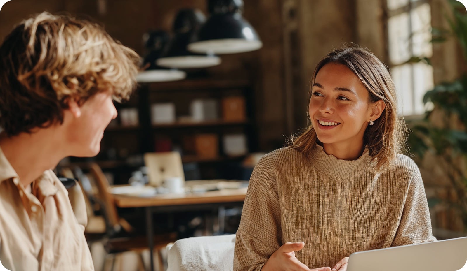 two young coworkers in a conversation.